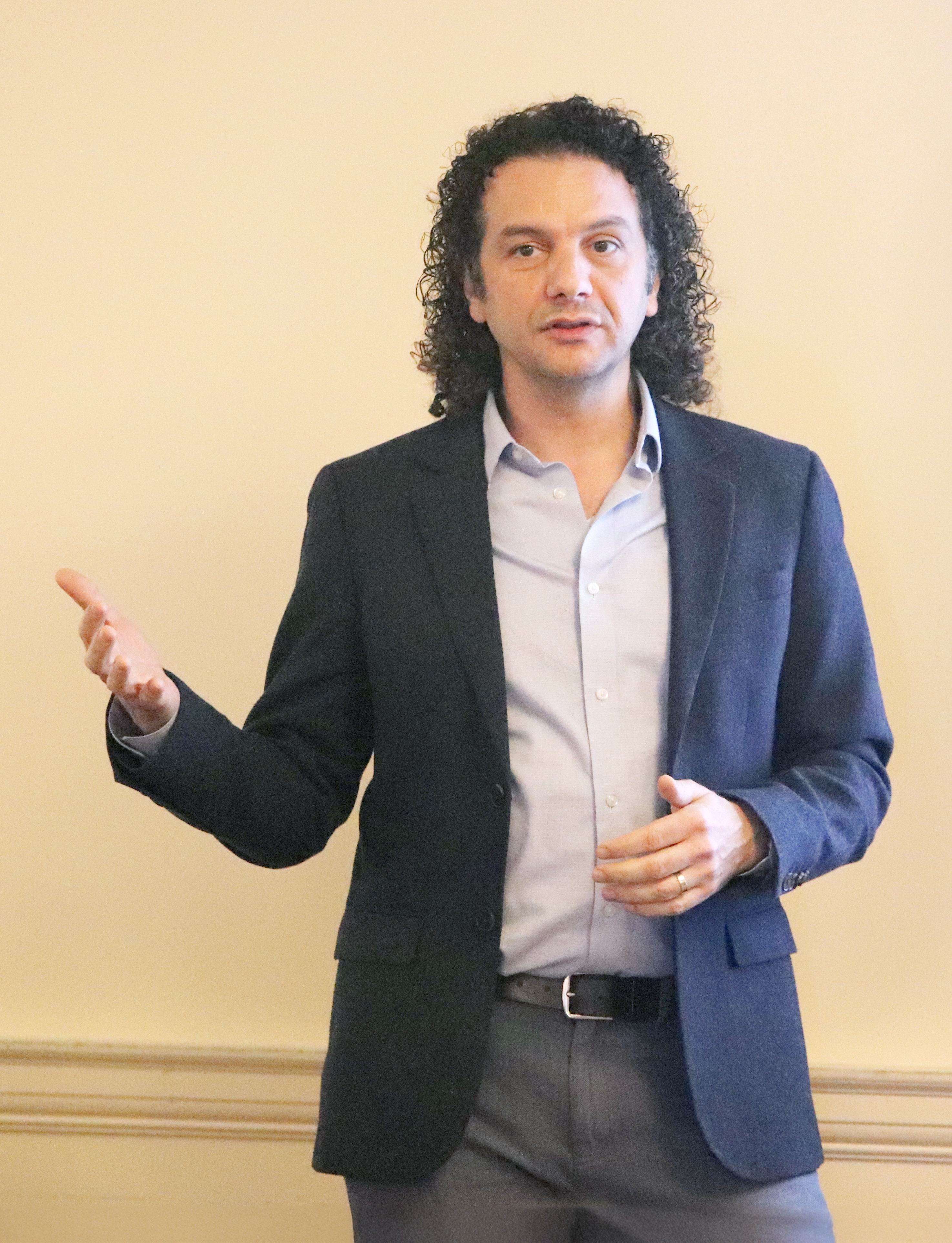 Shadi Atallah presenting at a lectern