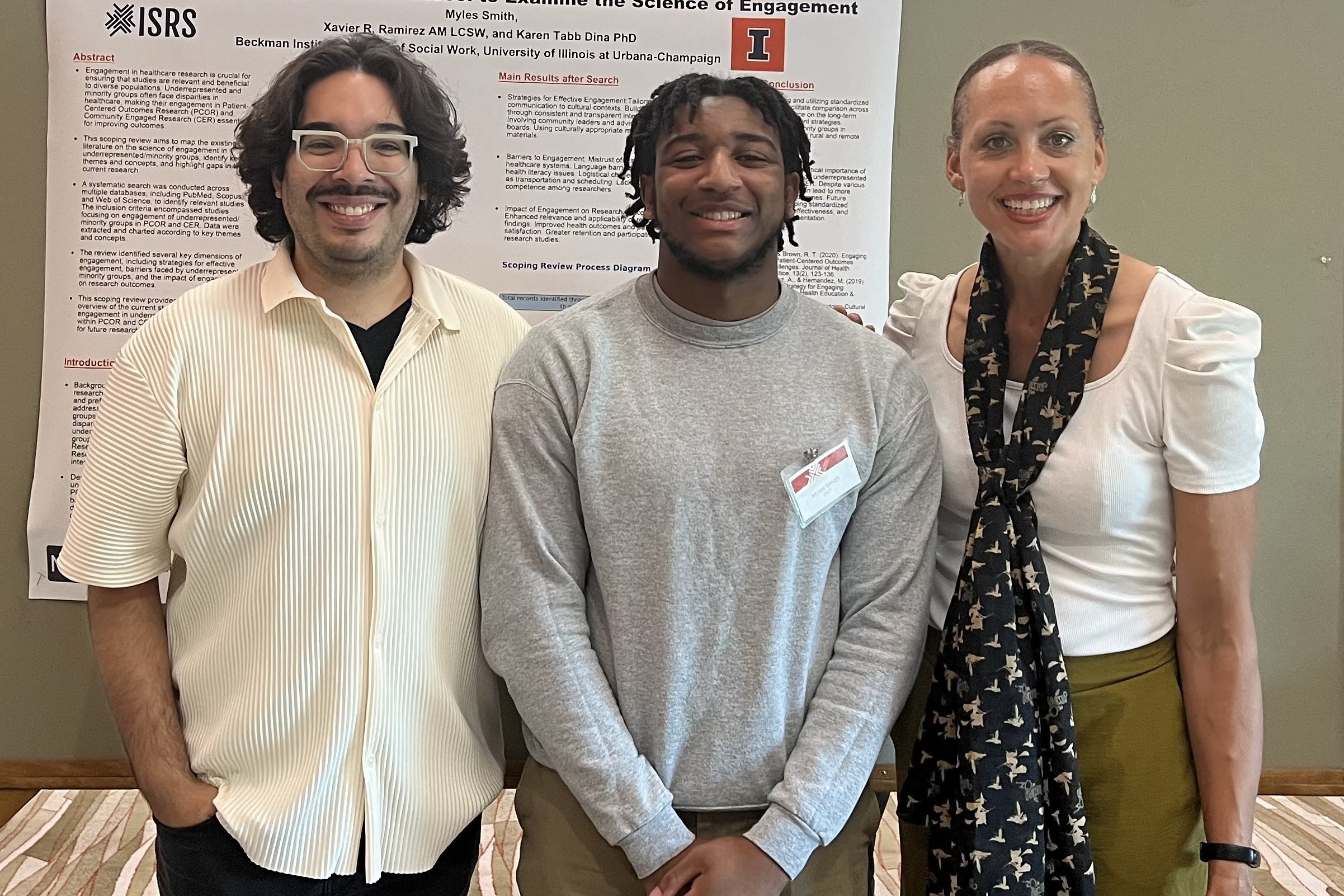 Myles Smith stands with faculty mentors in front of research poster.