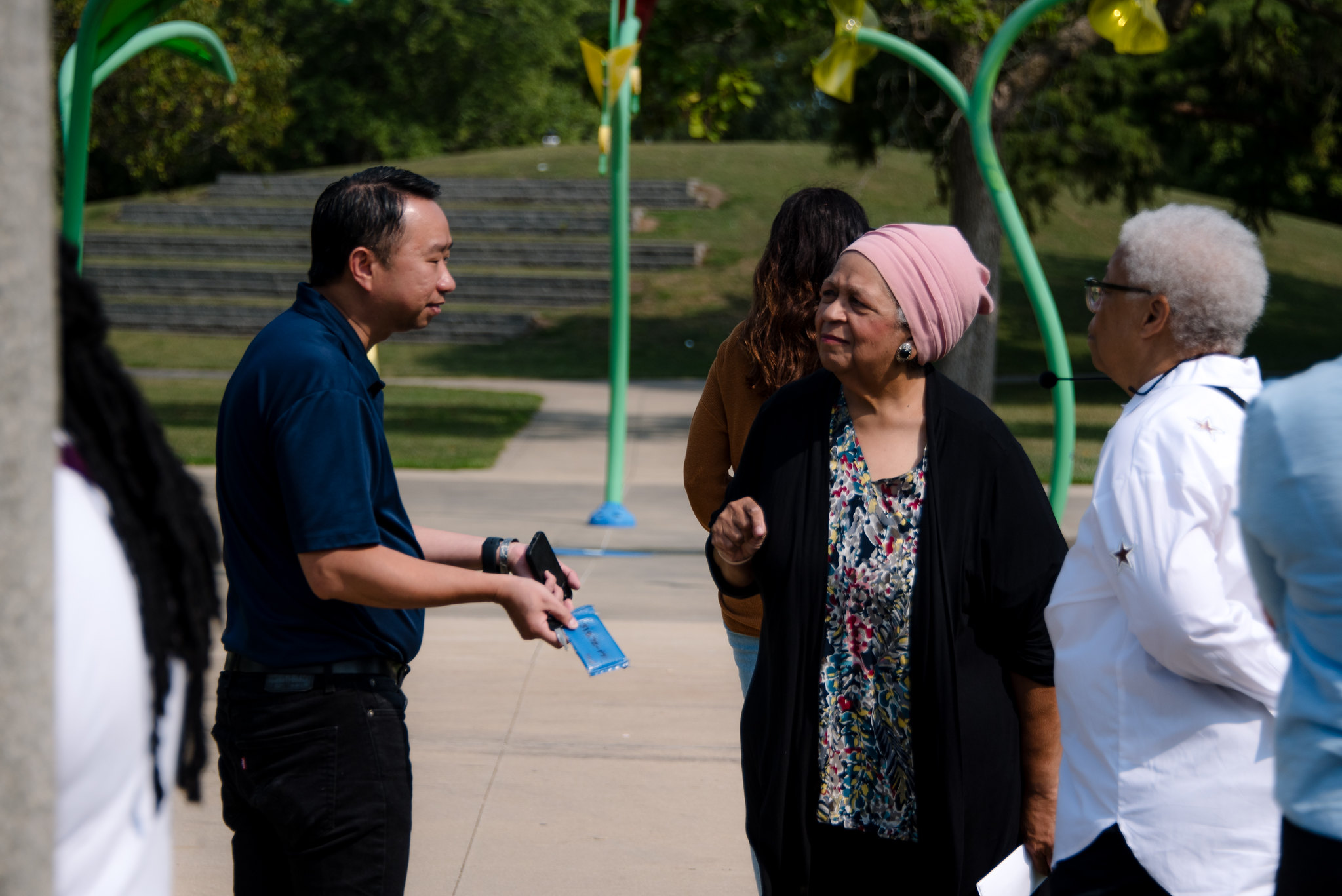 Kevin Tan, Angela Rivers, and Barbara Suggs-Mason talk at a park outdoors during local history tour