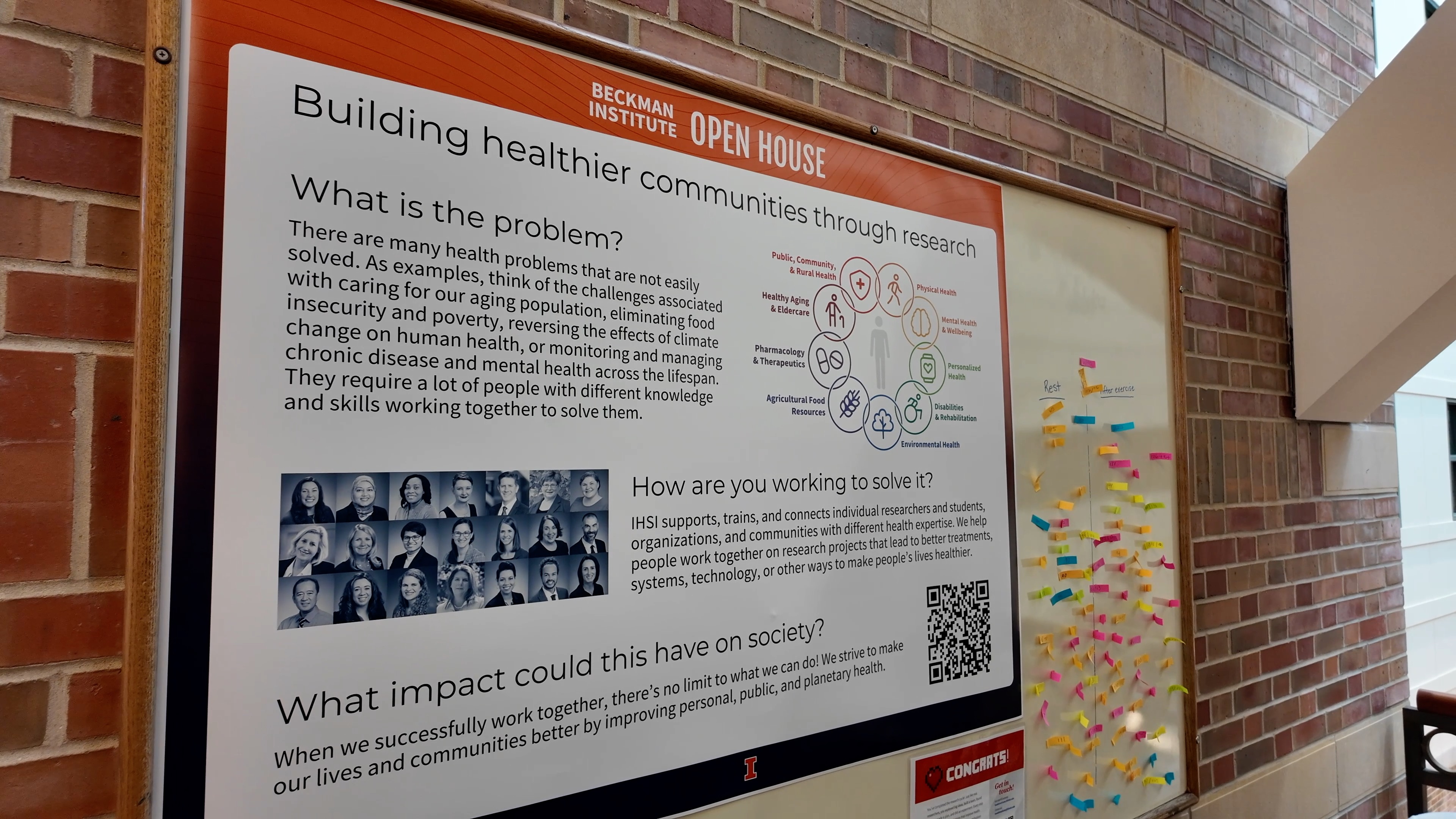 Poster hung on brick wall Building Healthier Communities Through Research with three sections What is the problem? How are you working to solve it? What impact could it have on society?