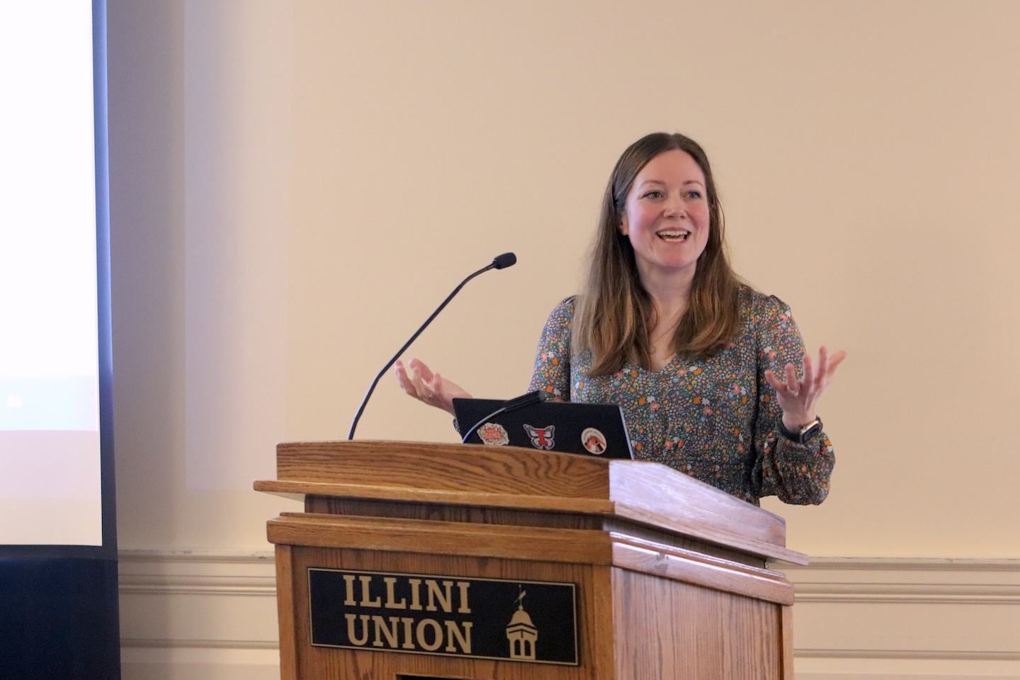 Rachel Garthe, presenting from a lectern, gestures and smiles at an unseen audience as she shares her vision.