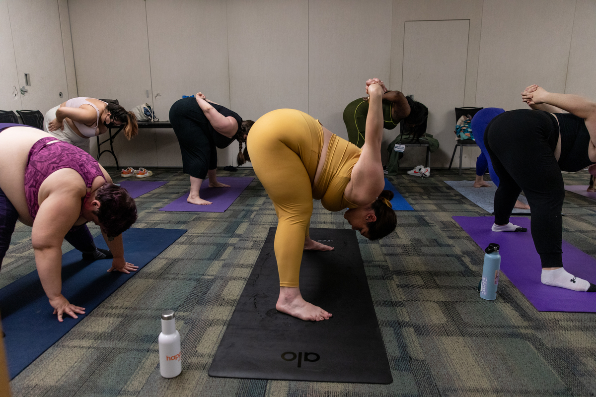 Attendees participate in the breathe and flow yoga class at Philly FatCon last month. During the session, instructor Laura Zales spoke about taking up space and proper weight distribution. Attendees ranged in age, size and gender. Jackie Molloy for NPR
