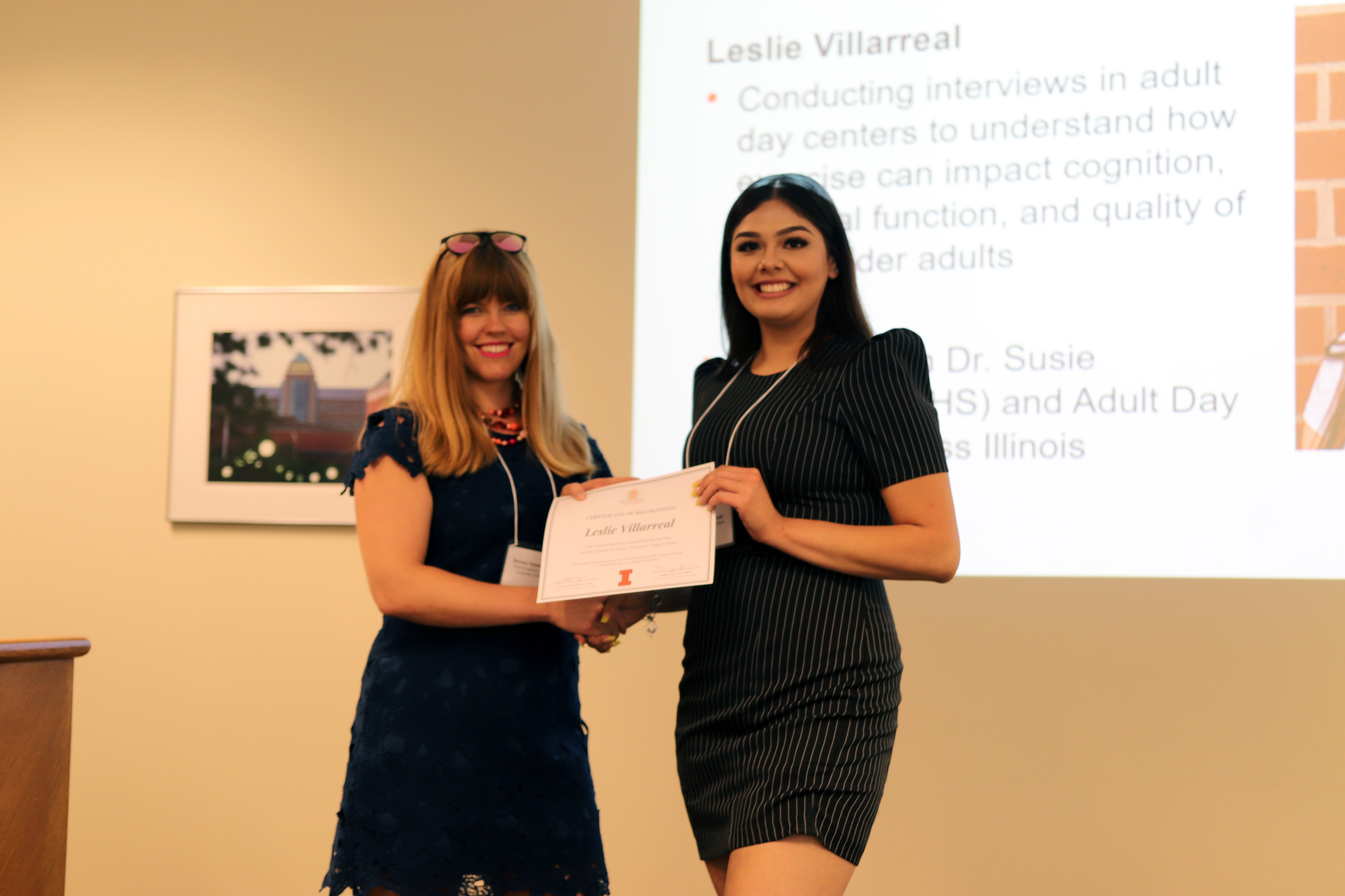 Leslie receiving her certificate from Kelsey Hassevoort