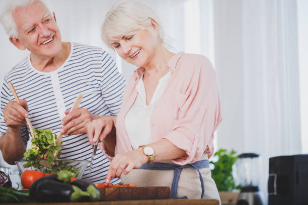 senior couple preparing a salad