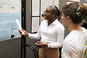 Stella Emazue presents her poster at the 2023 Community-Academic Scholars Poster Session &amp;amp;amp;amp;amp;amp; Celebration